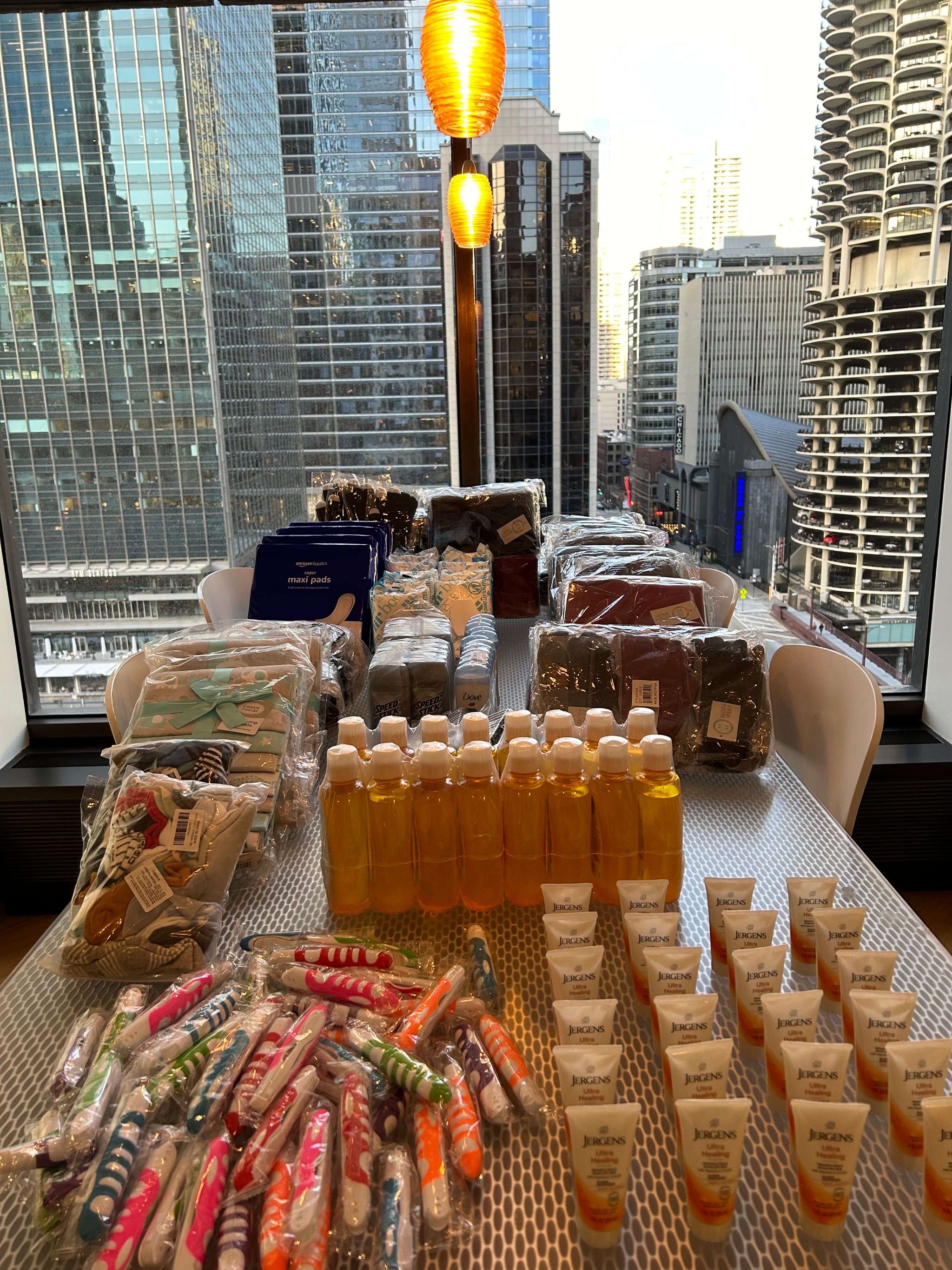 Various essentials and toiletries arranged on a conference table.