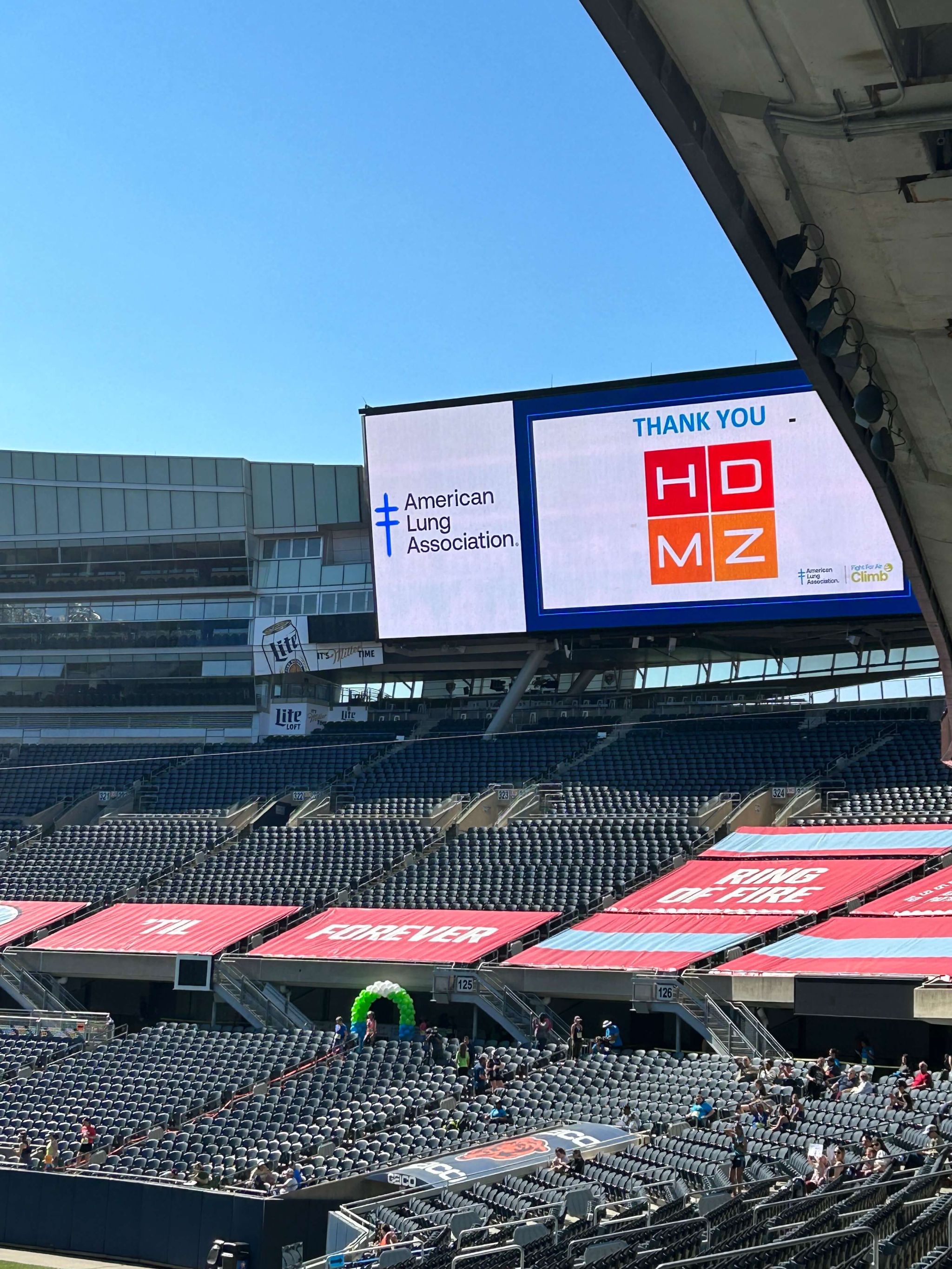 A view of Soldier Field showing an electronic billboard. Text: Thank you HDMZ!
