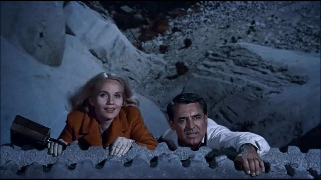 A movie still from North by Northwest, featuring Cary Grant and Eva Marie Saint.