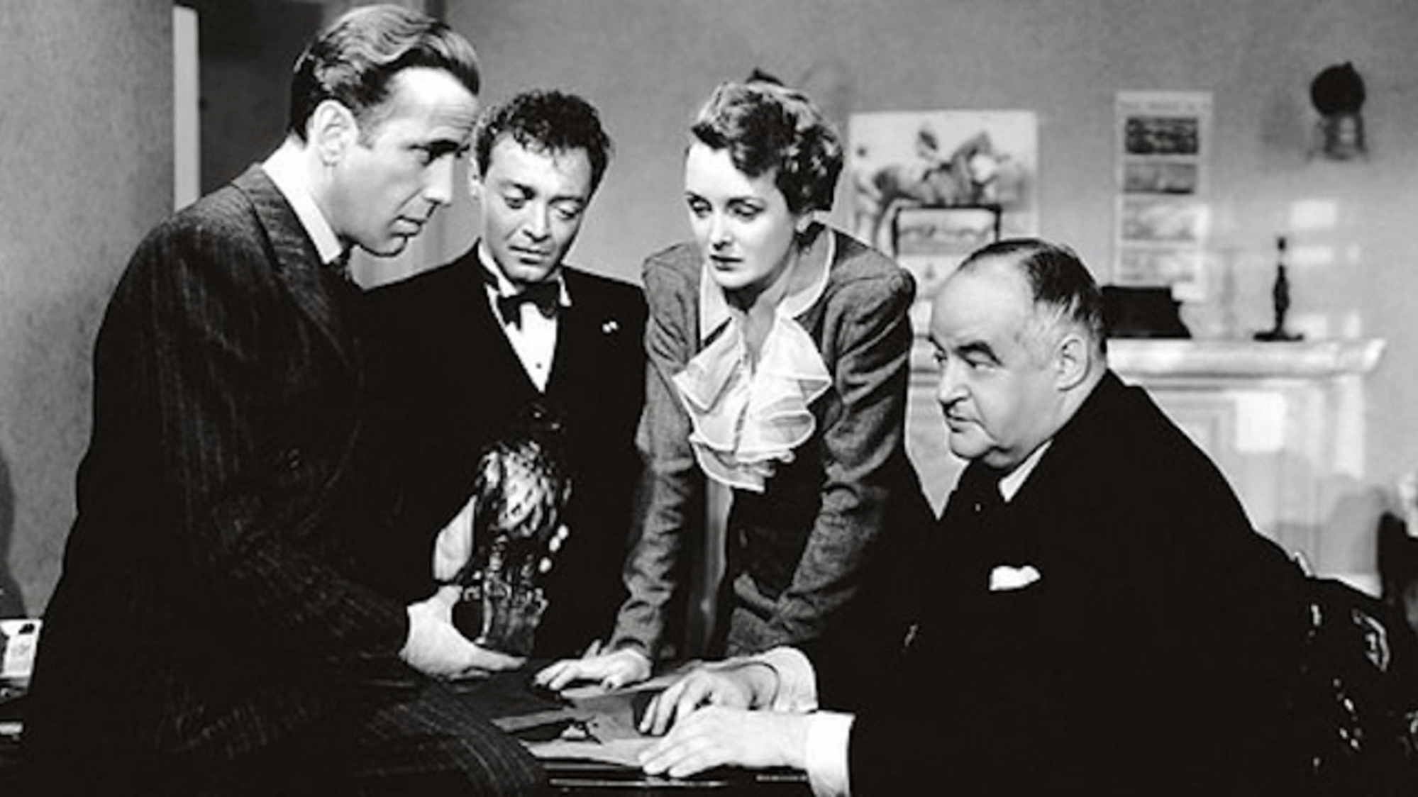 A still of the main cast from the film The Maltese Falcon.