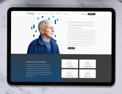 A tablet screen showing the Castle Biosciences homepage.